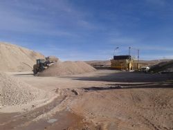 Crushed tincal ore being loaded into the feed bin.
