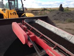 Ground phosphate collected in loader bucket