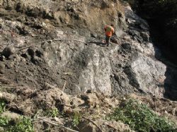 Figure 4. Worker washing down the newly excavated pegmatite structure located south of the North Aubry prospect to enable the geological team to review and identify the various lithium mineralisation zones. 