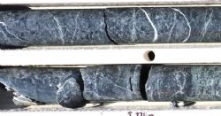 AWN001 drill core at 273.0 m and 274.0 m: 30cm core lengths – Massive brecciated magnetite skarn with strong chlorite alteration, quartz-calcite veins and fracture-fill. 