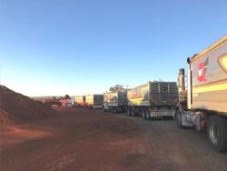 Loaded trucks leaving mine site for port