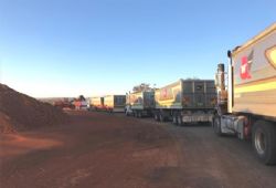 Loaded trucks leaving mine site for port