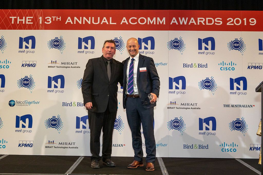 Hamish Lee, VP Sales APAC, Speedcast, receiving the ACOMMS award